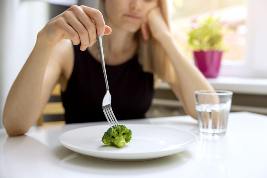dieting problems, eating disorder – unhappy woman looking at sma